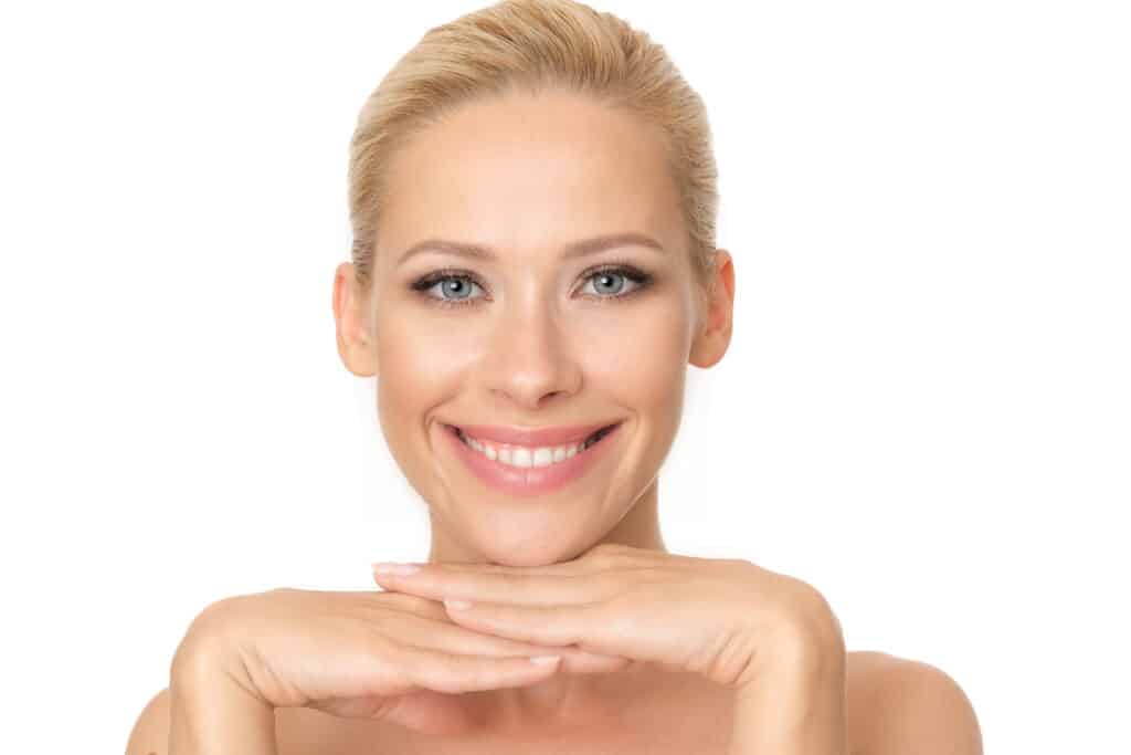 Beautiful woman with a perfect complexion promoting Botox in Groton, isolated on white background